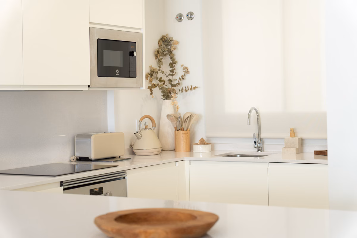 Open-plan kitchen-lounge behind large glazing