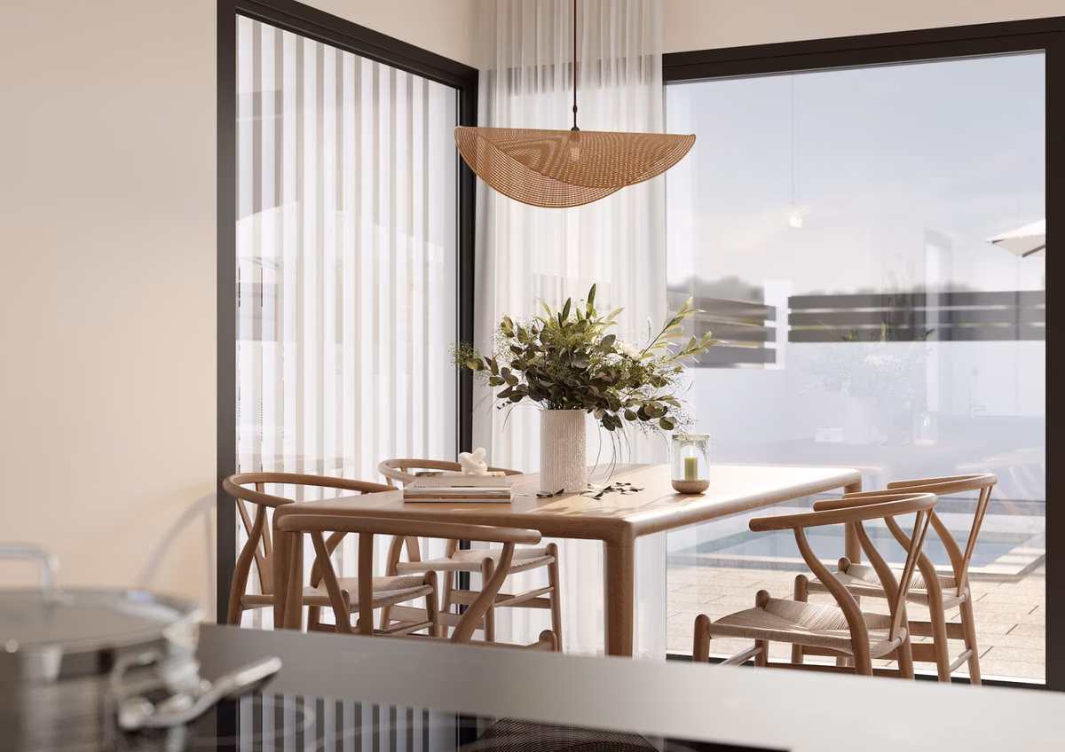 Dining table by a corner window looking onto the pool terrace at La Gomera Star