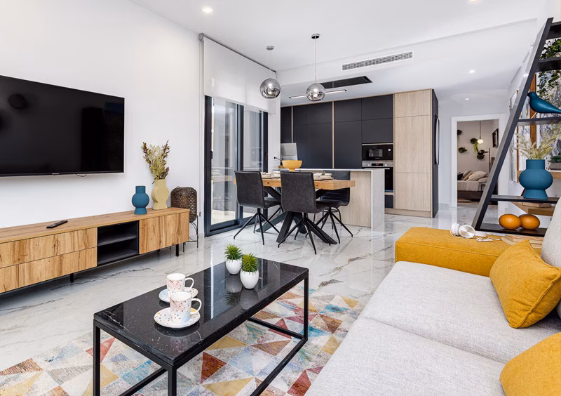 Living room open to the kitchen in the La Hoya show apartment