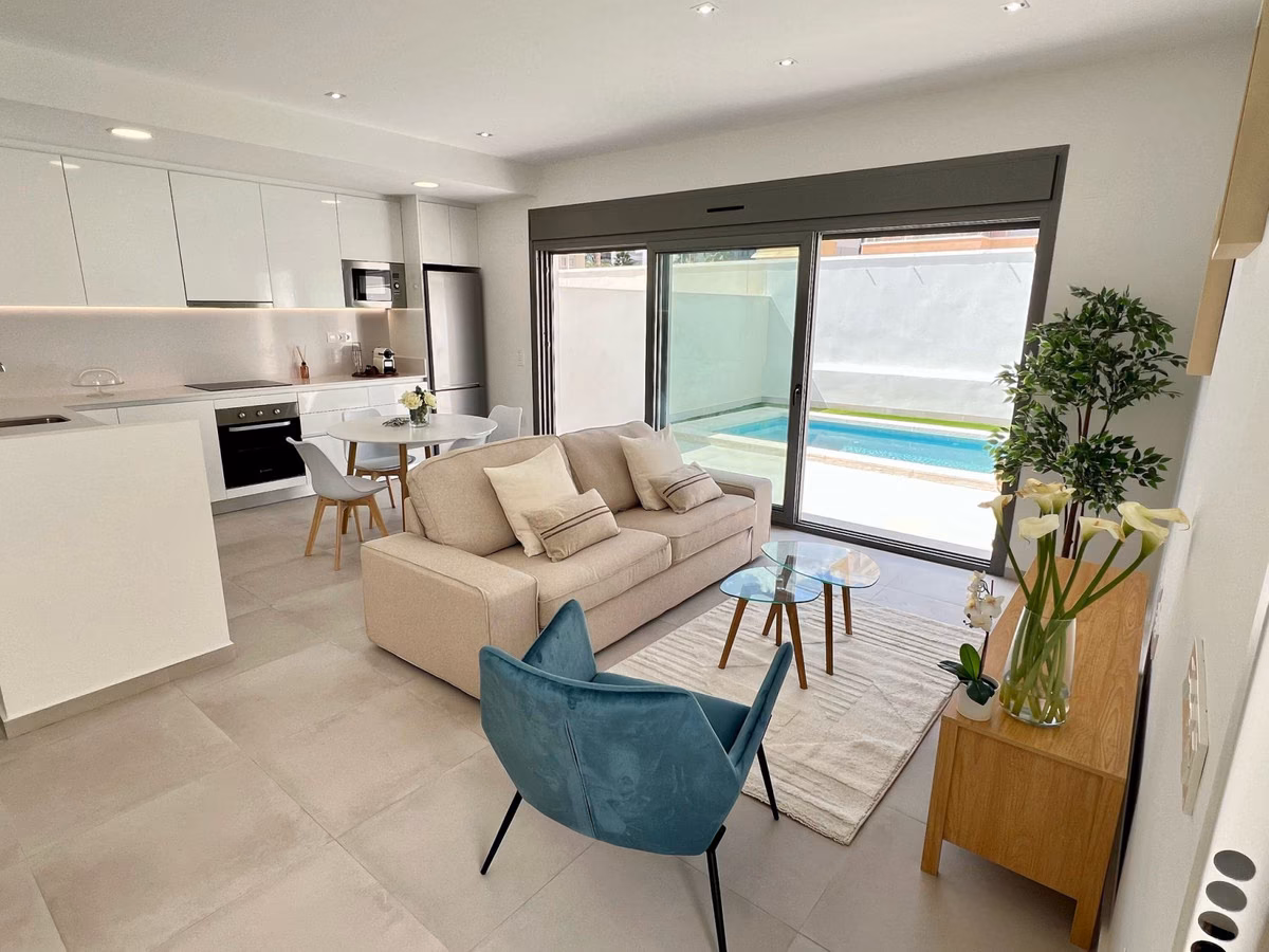 Living room with sofa and glass doors onto the pool