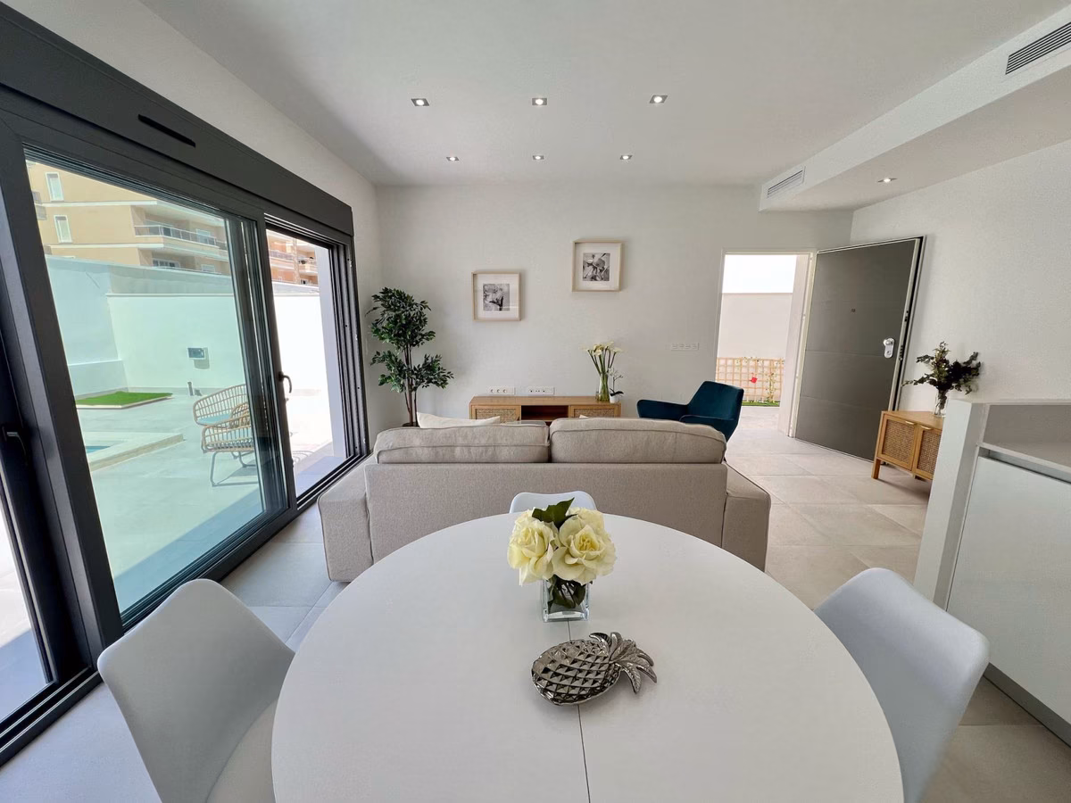 Dining table and lounge with sliding doors to the terrace