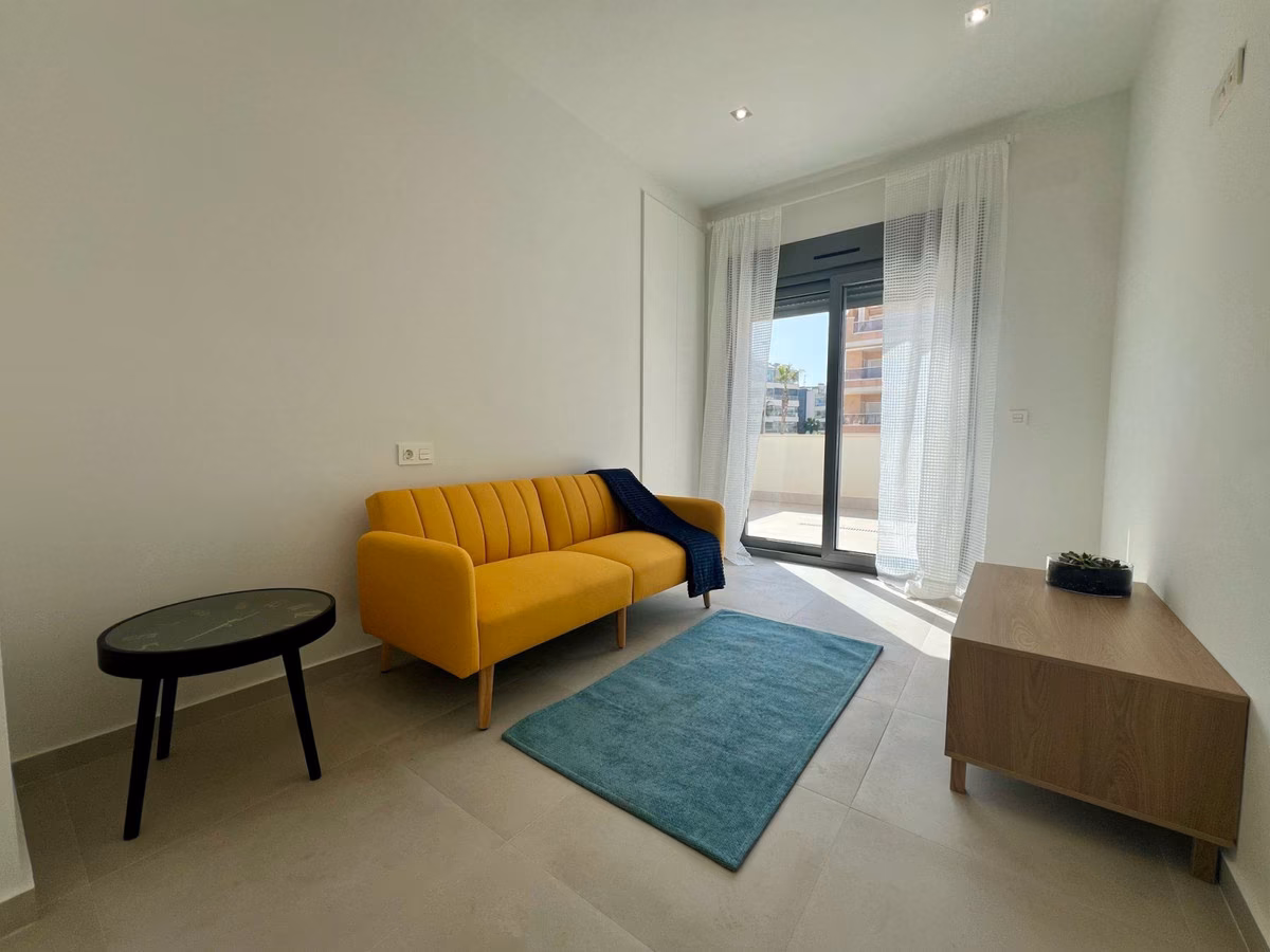 Bright room with yellow sofa and terrace door