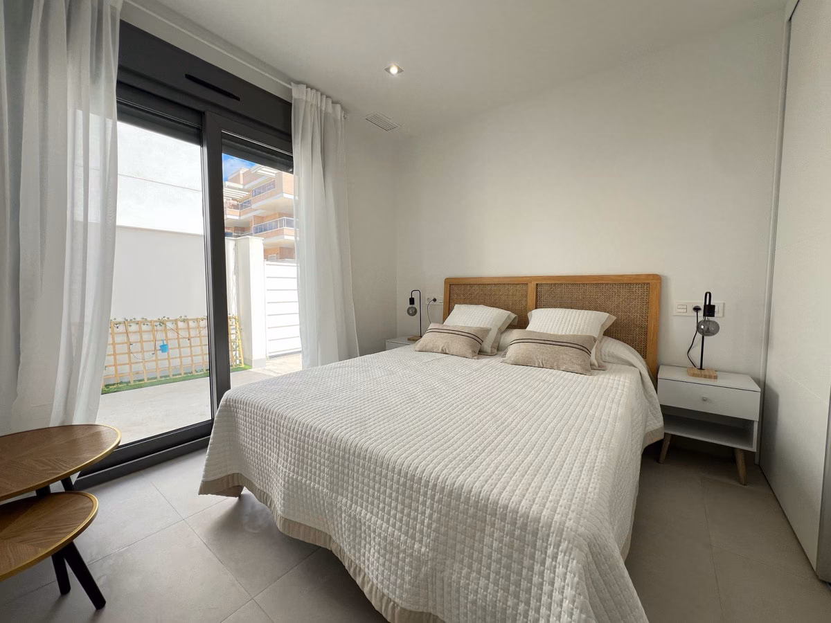 Bedroom with double bed and sliding door to the terrace