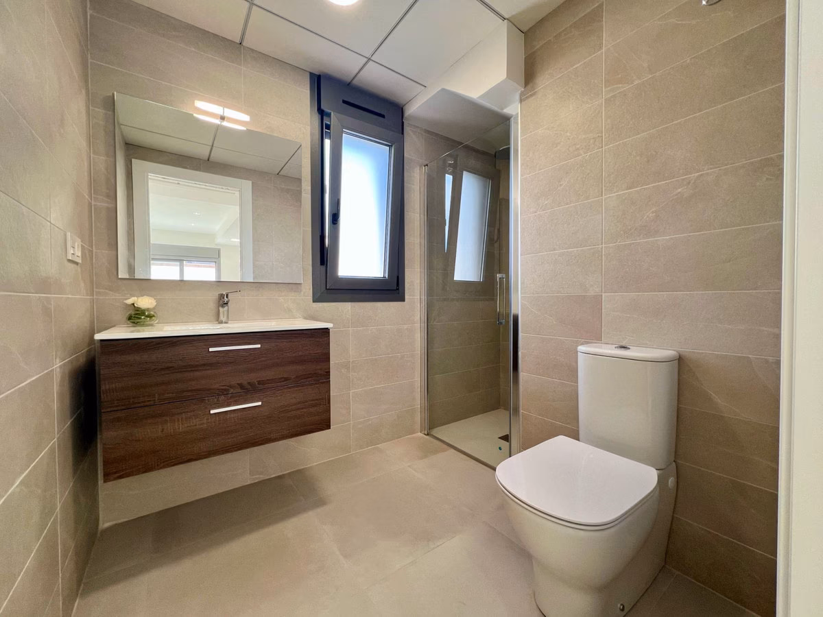 Bathroom with wooden vanity unit and mirror