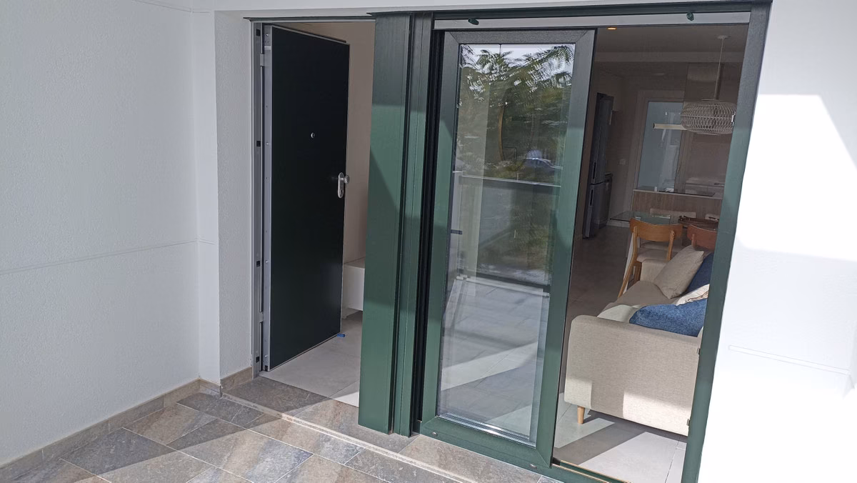 Entrance door and sliding glass door onto the terrace