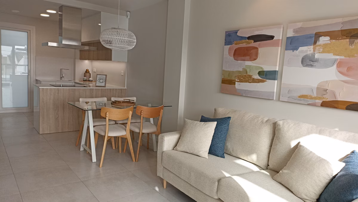 Living area with sofa and dining table by the open kitchen