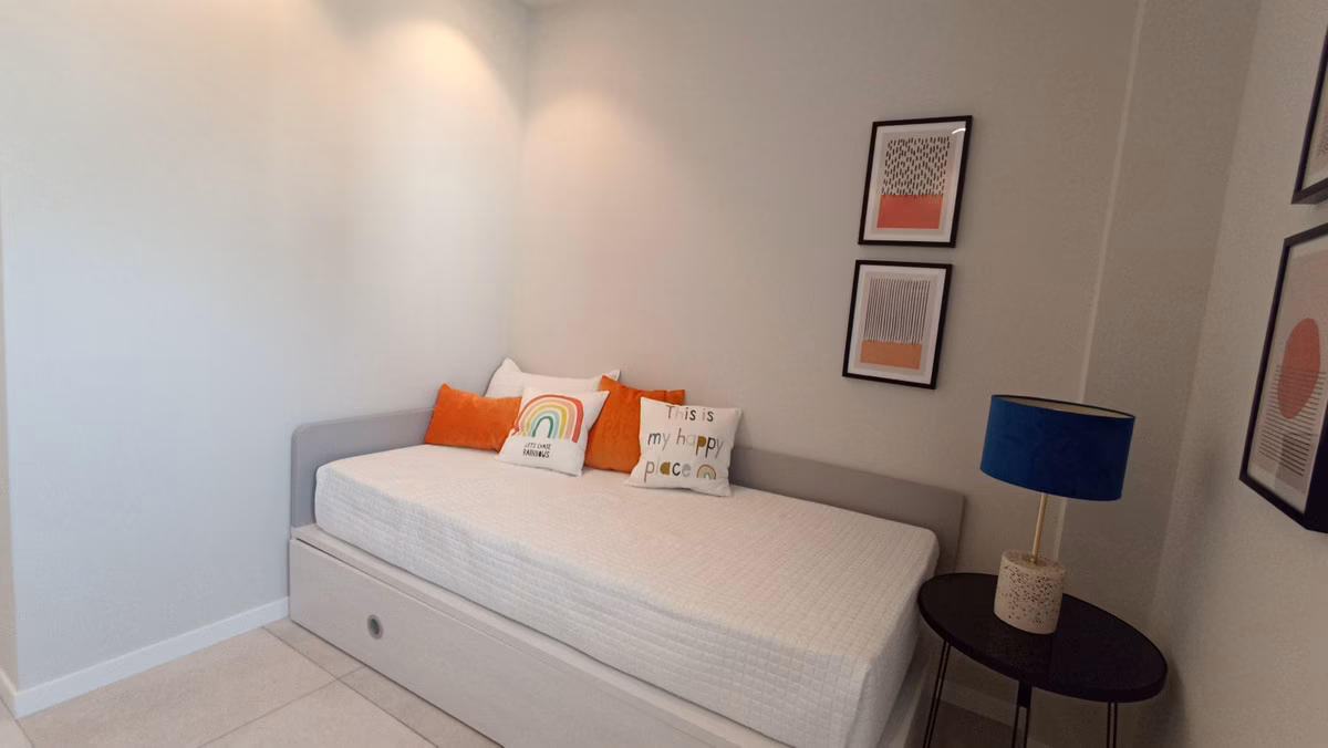 Second bedroom with a day bed and colourful cushions