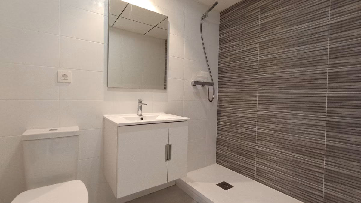 Bathroom with shower tray and white vanity unit