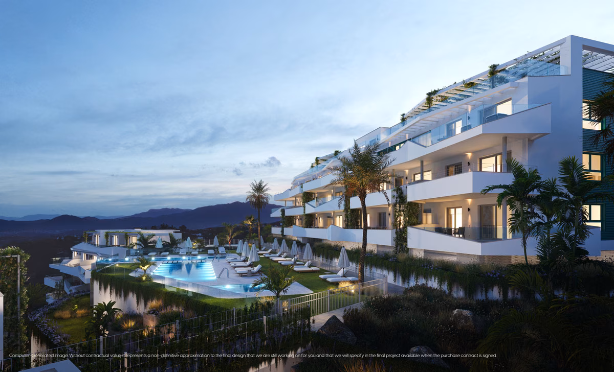 Stepped white buildings and the lit communal pool at dusk