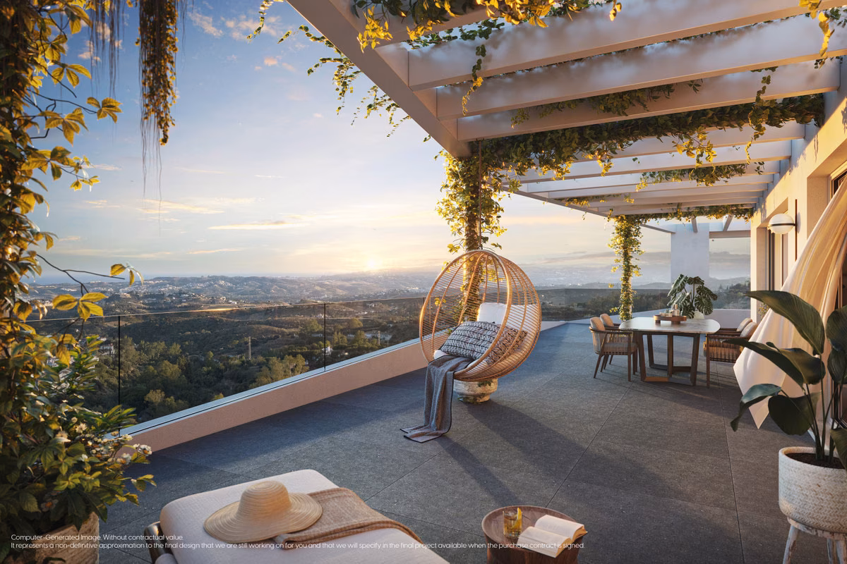 Covered terrace with hanging chair and a view over the hills at sunset