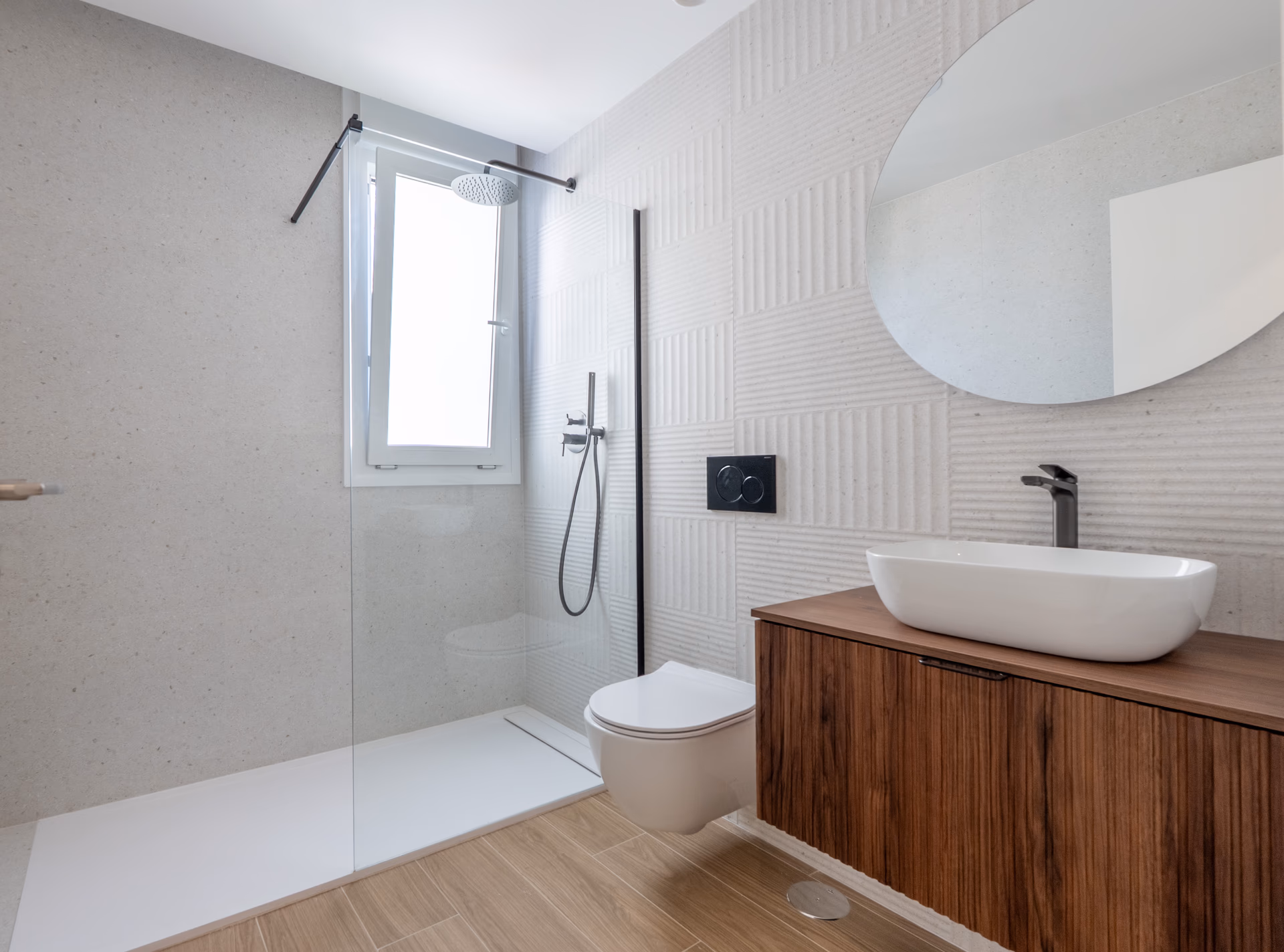 En-suite bathroom with ribbed stone tiles and walk-in shower