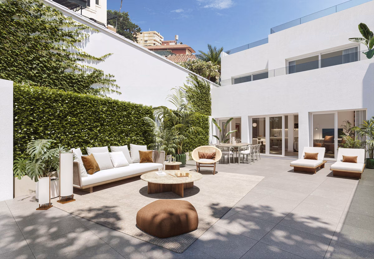 Gartenterrasse mit Sofas vor der weißen Fassade von Monte Sancha 28 (Visualisierung)