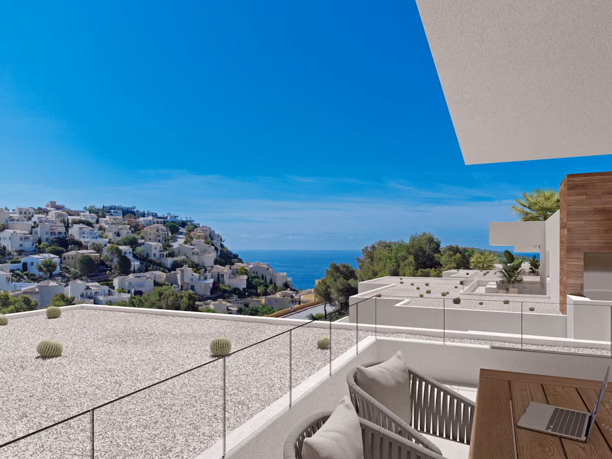 Blick von einer Terrasse über das Kiesdach und die Glasbrüstung auf Villen und Meer