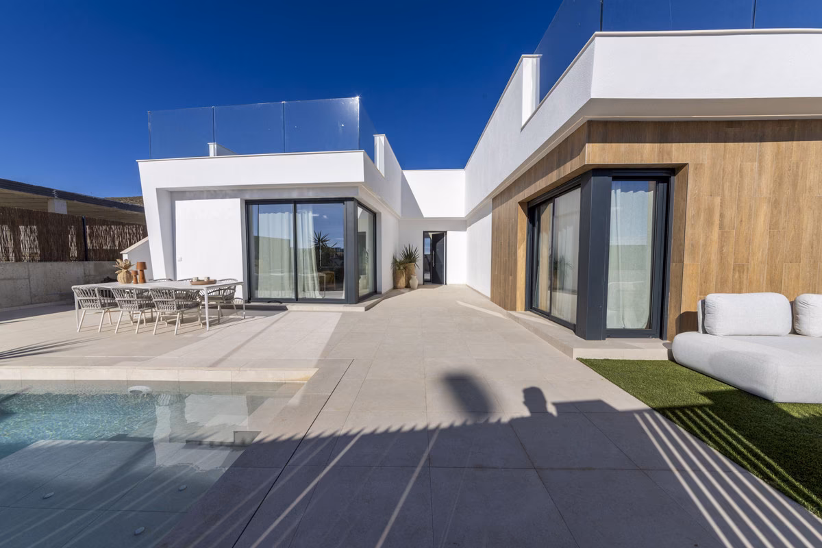Terrace of the Montemar show villa with dining table, pool and outdoor sofa