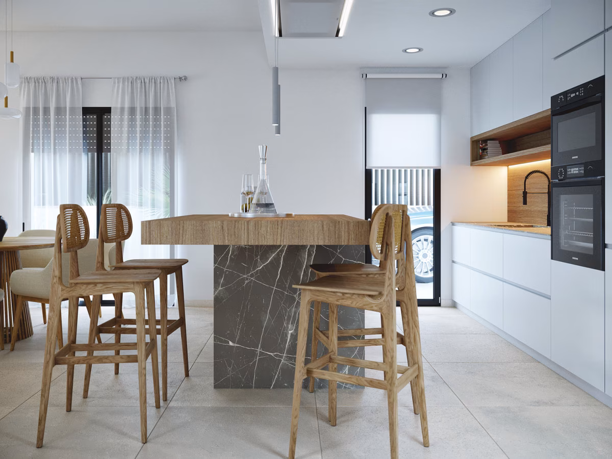 Kitchen island with bar stools and built-in ovens in a Montemar villa