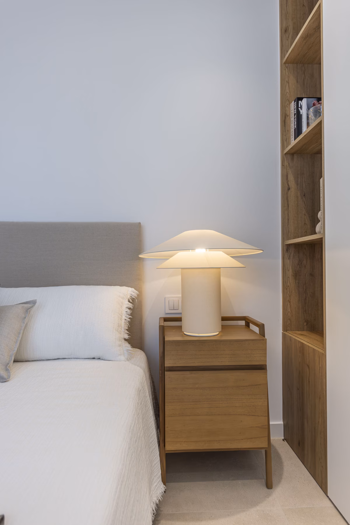 Bedside table with lamp and shelving in a Montemar villa bedroom