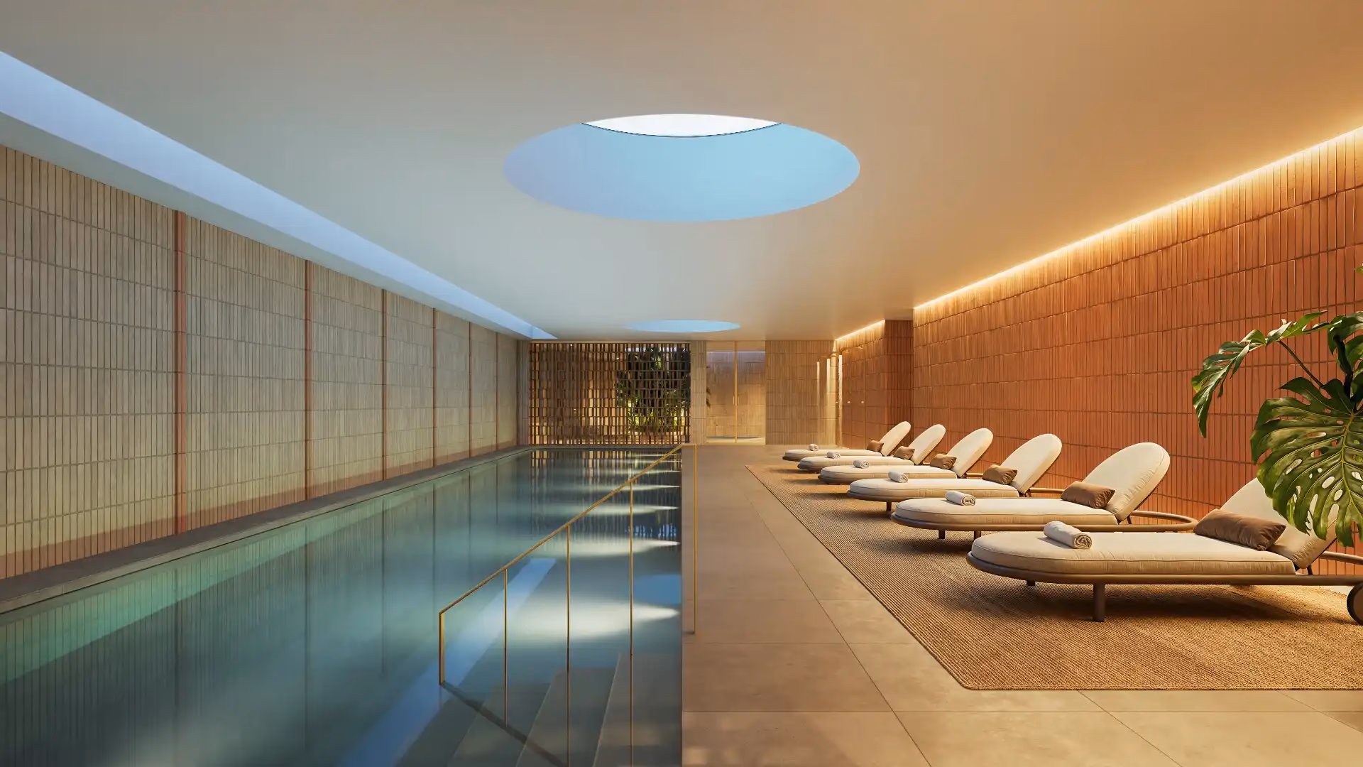 Light-filled residents lounge with a kitchen under a skylight at NAVEN