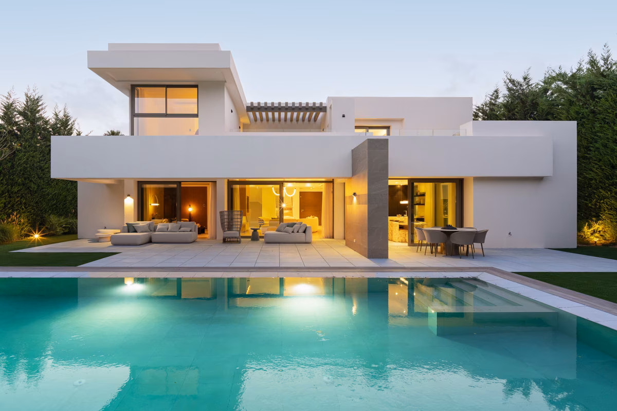 Villa and pool lit at dusk