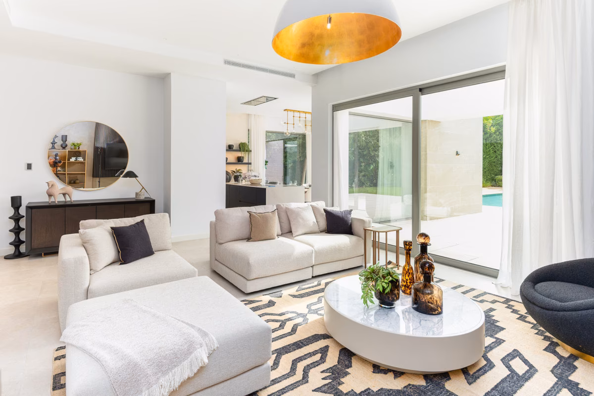 Sitting area with patterned rug and garden view