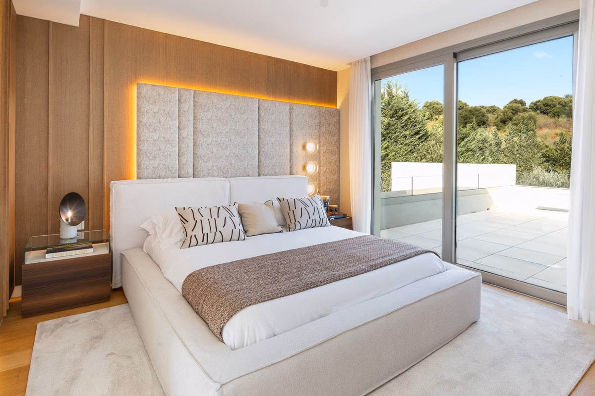 Bedroom with upholstered headboard and terrace doors