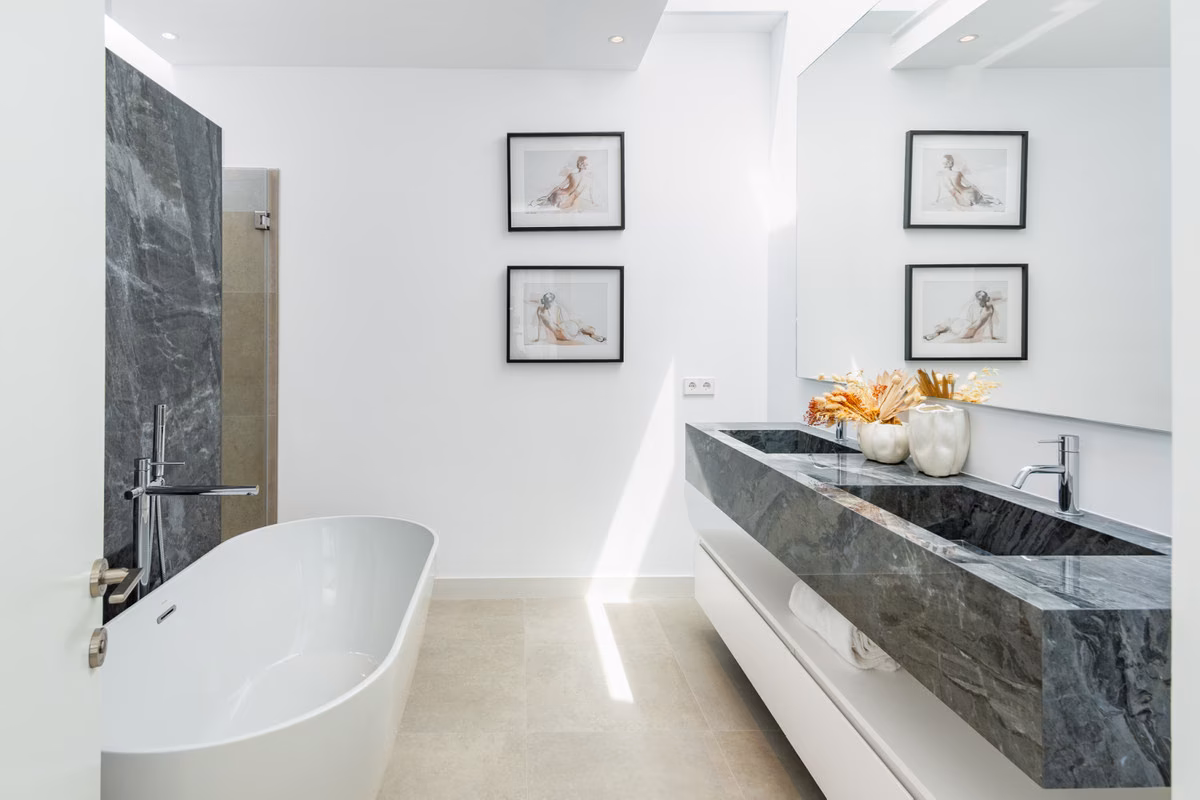 Bathroom with freestanding bath and stone double basin
