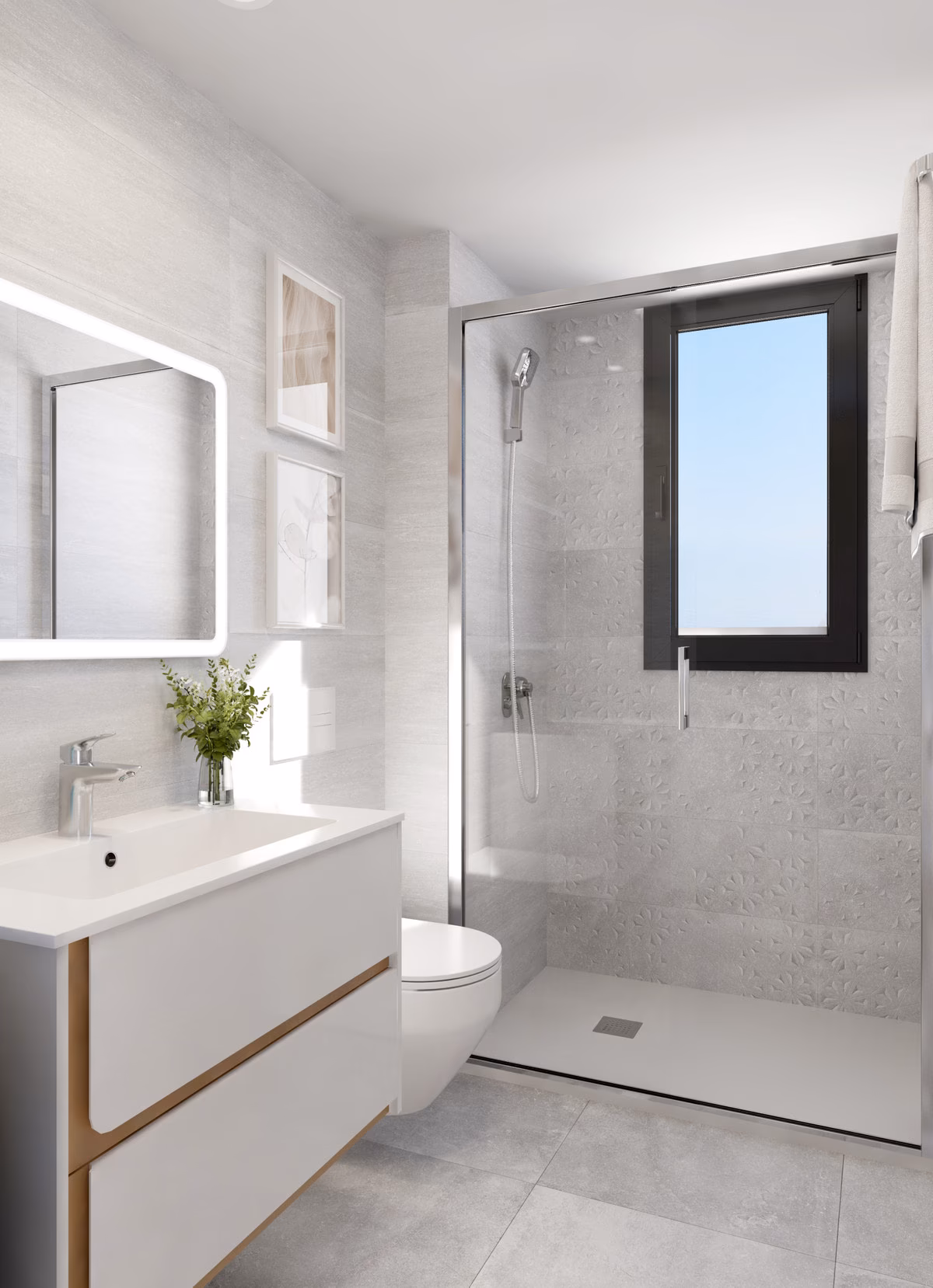 Baño con mampara de vidrio en la ducha y azulejos grises