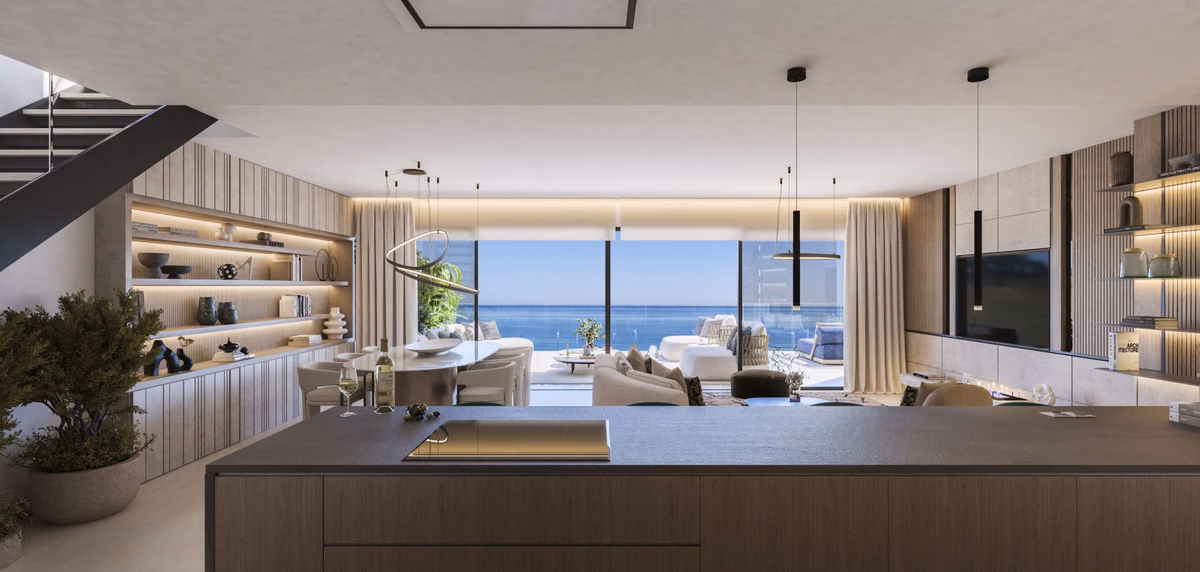 Open-plan living room and kitchen with a staircase and sea view