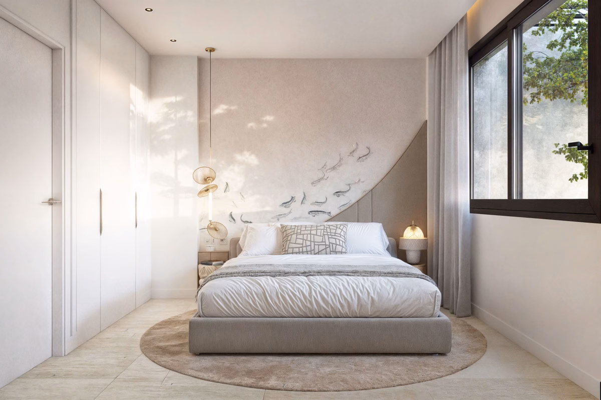Bedroom with a large bed, fitted wardrobe and window to the garden