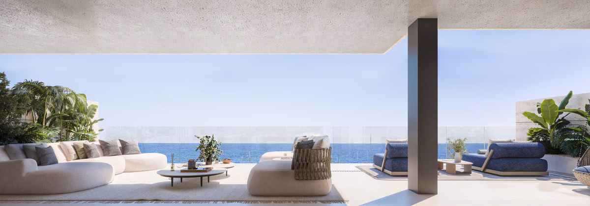 Covered terrace with low sofas looking out to the sea