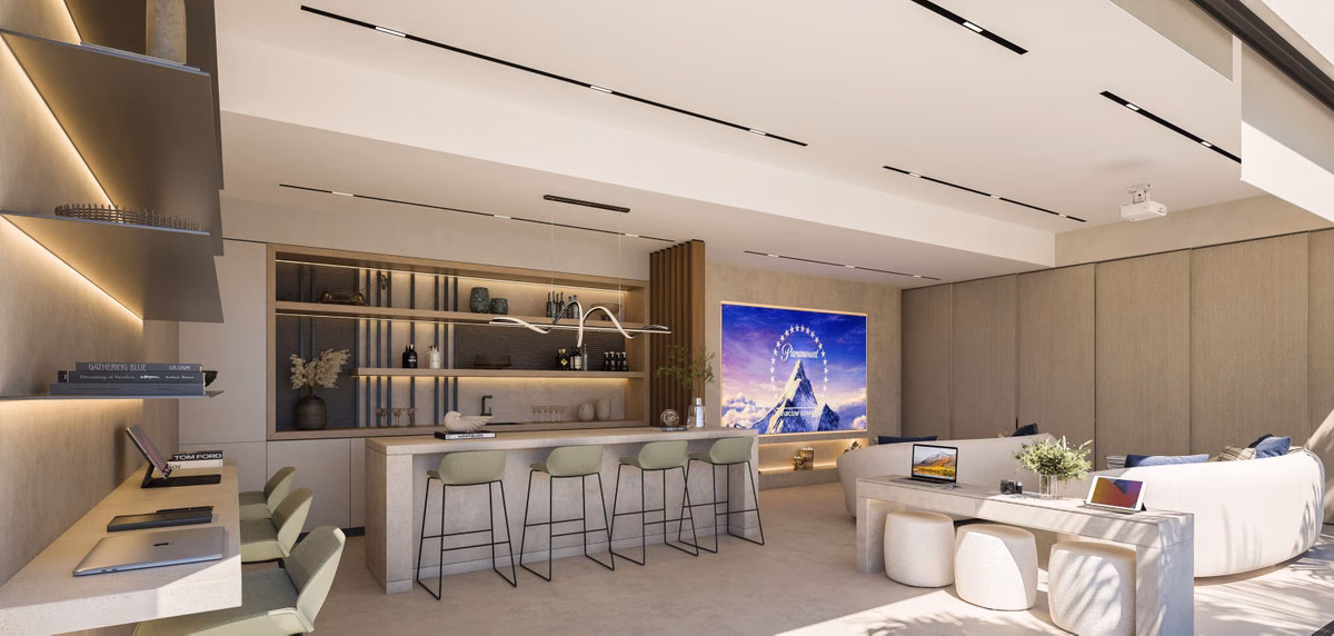 Lounge with a projector screen and kitchen bar behind