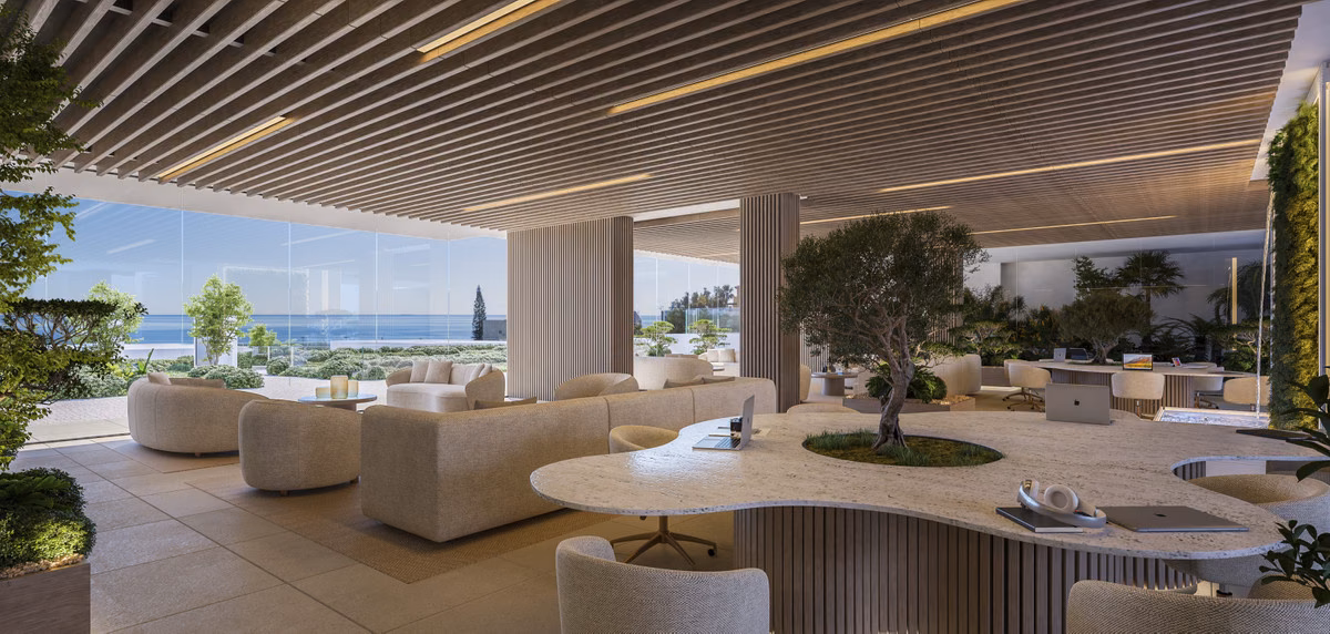 Communal lounge with sofas under a slatted ceiling and sea views