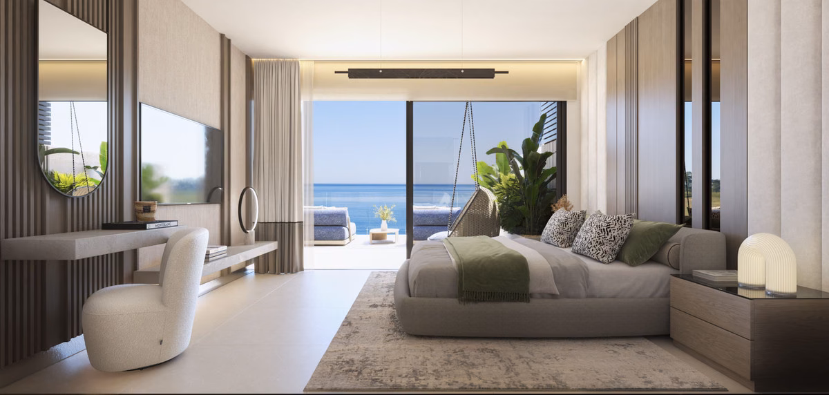 Bedroom with a sofa at the foot of the bed and a sea view