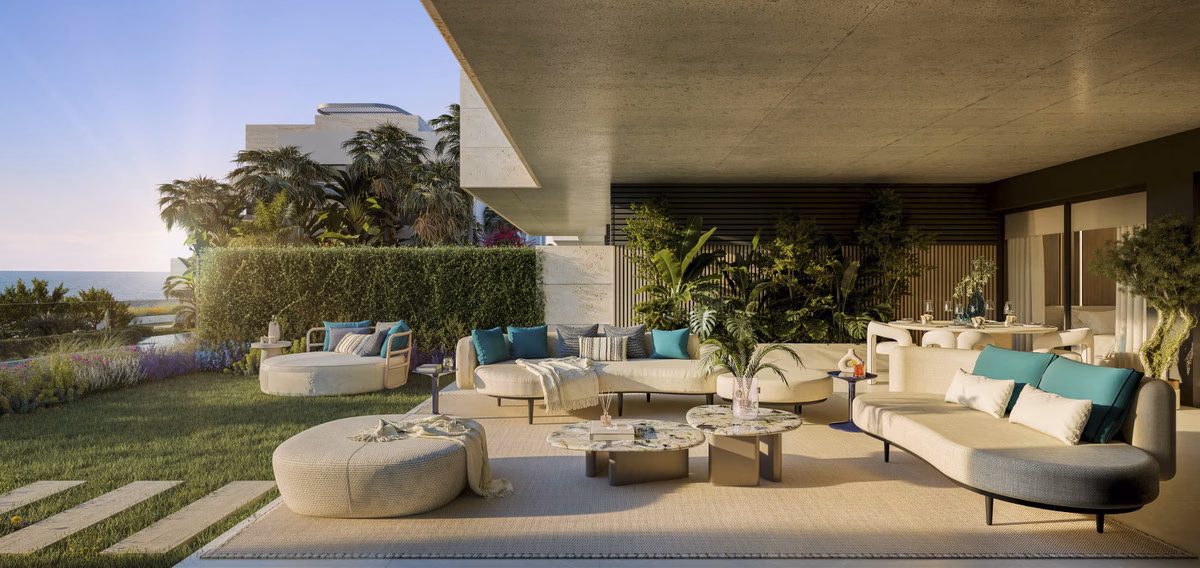 Garden terrace with sofas and lawn steps at sunset