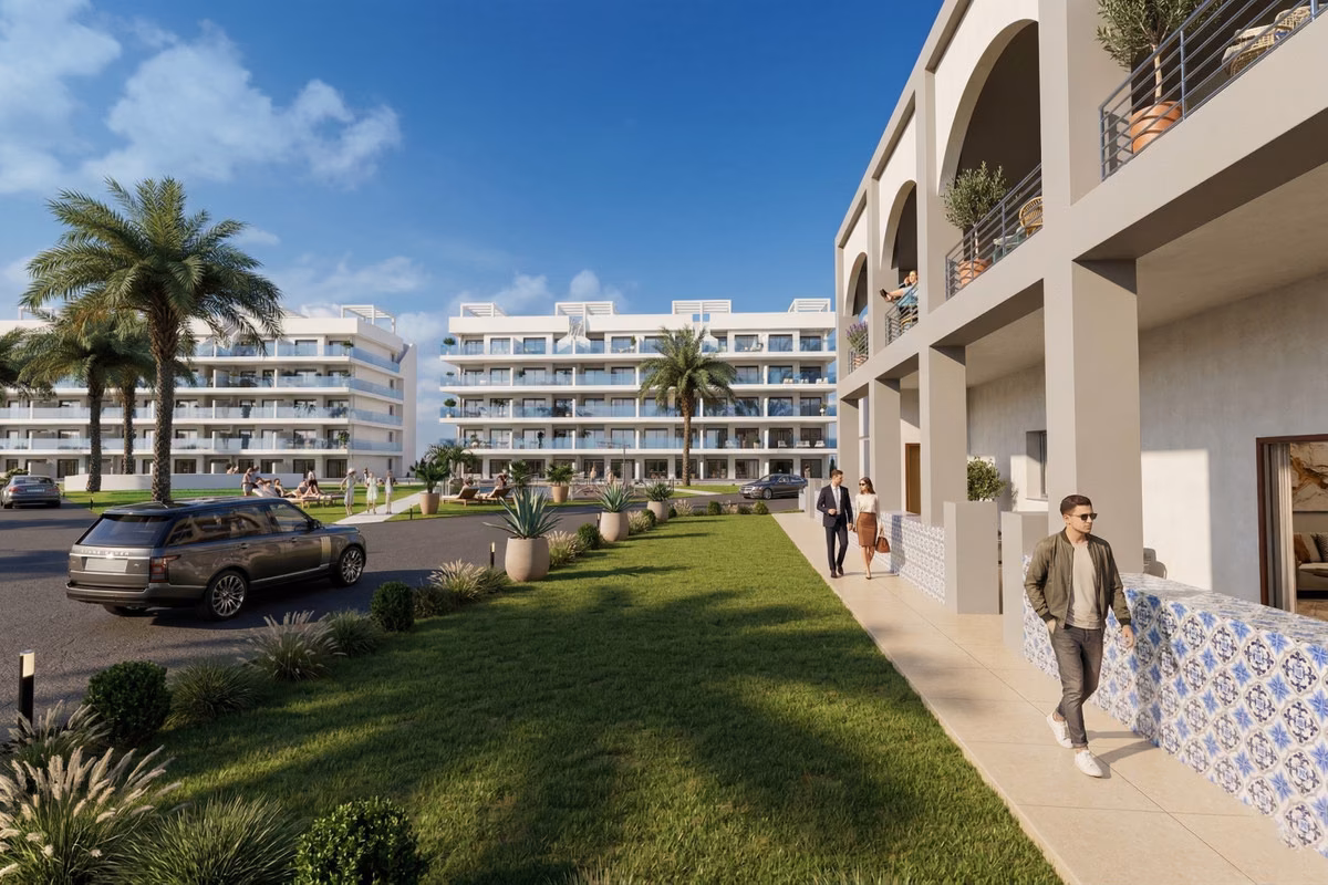 Lawn and walkway beside the ground-floor arcades with blue-and-white tiled planters