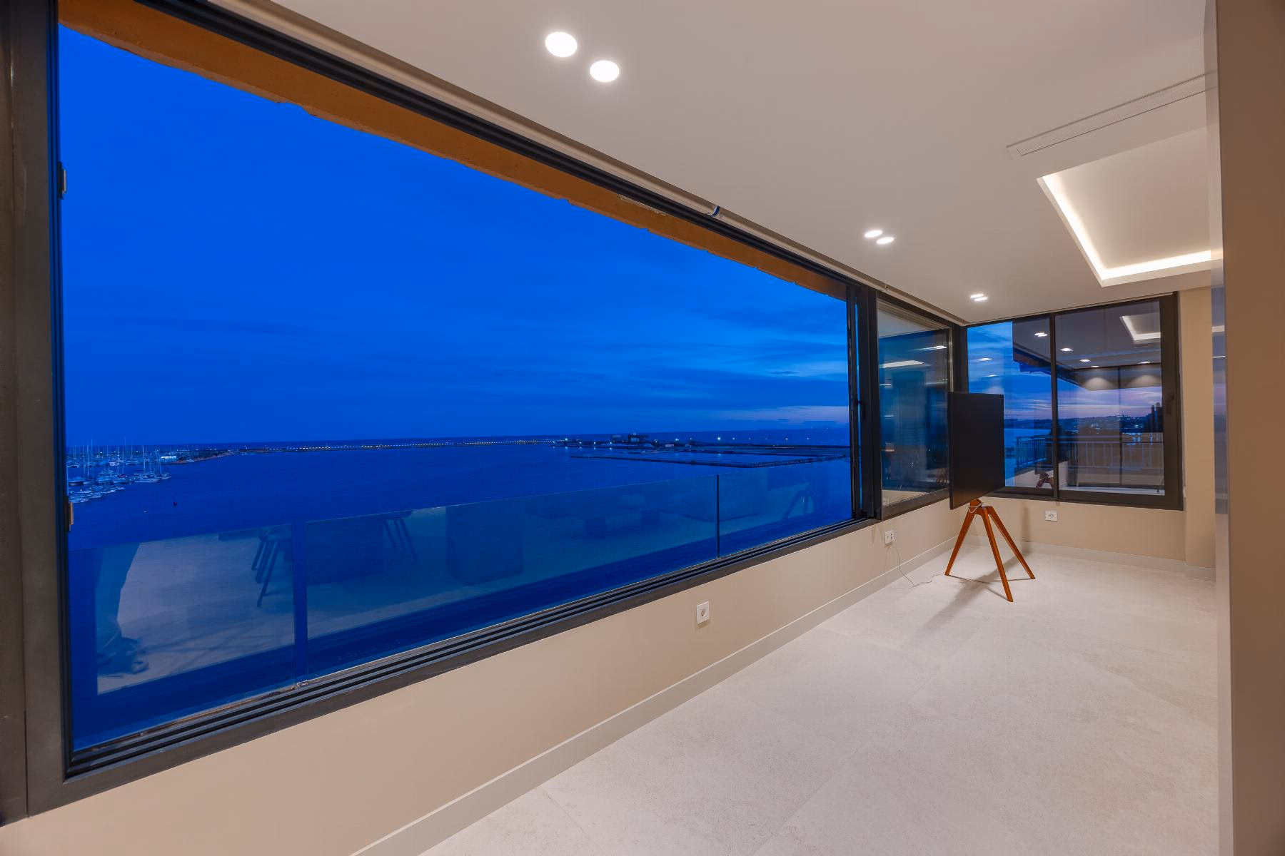 Panoramic corner window with the sea and the lights of the port of Torrevieja