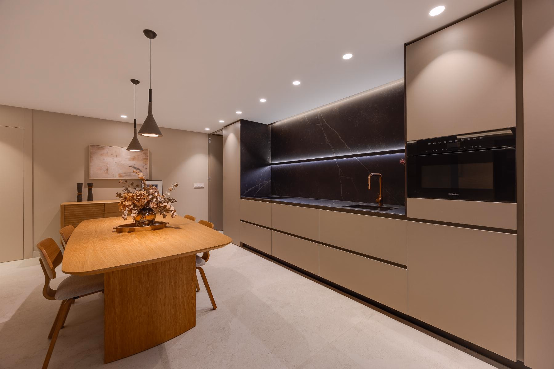 Kitchen wall with built-in oven, microwave and integrated fridge