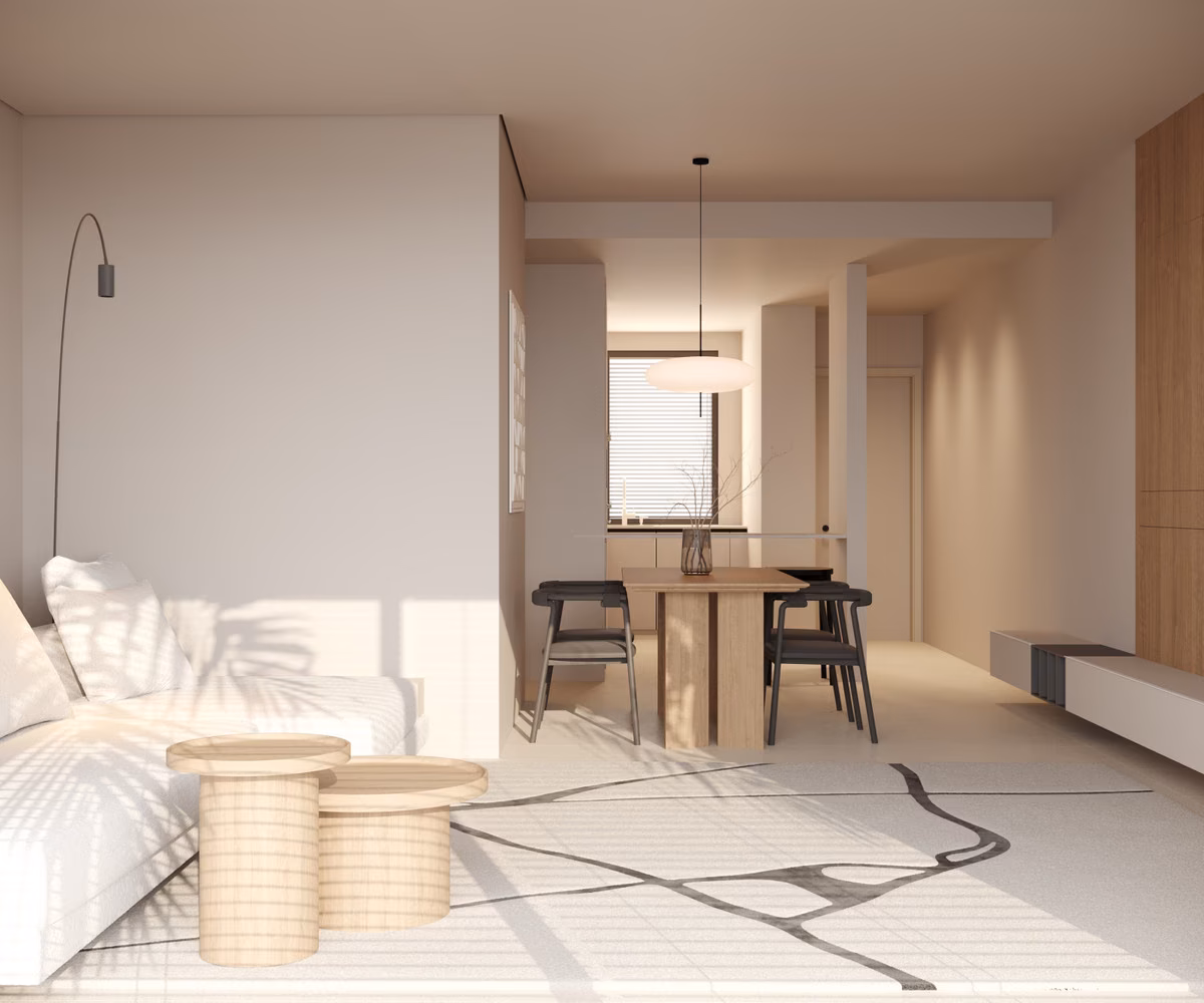 Estancia luminosa con una cama en primer plano y la mesa de comedor al fondo