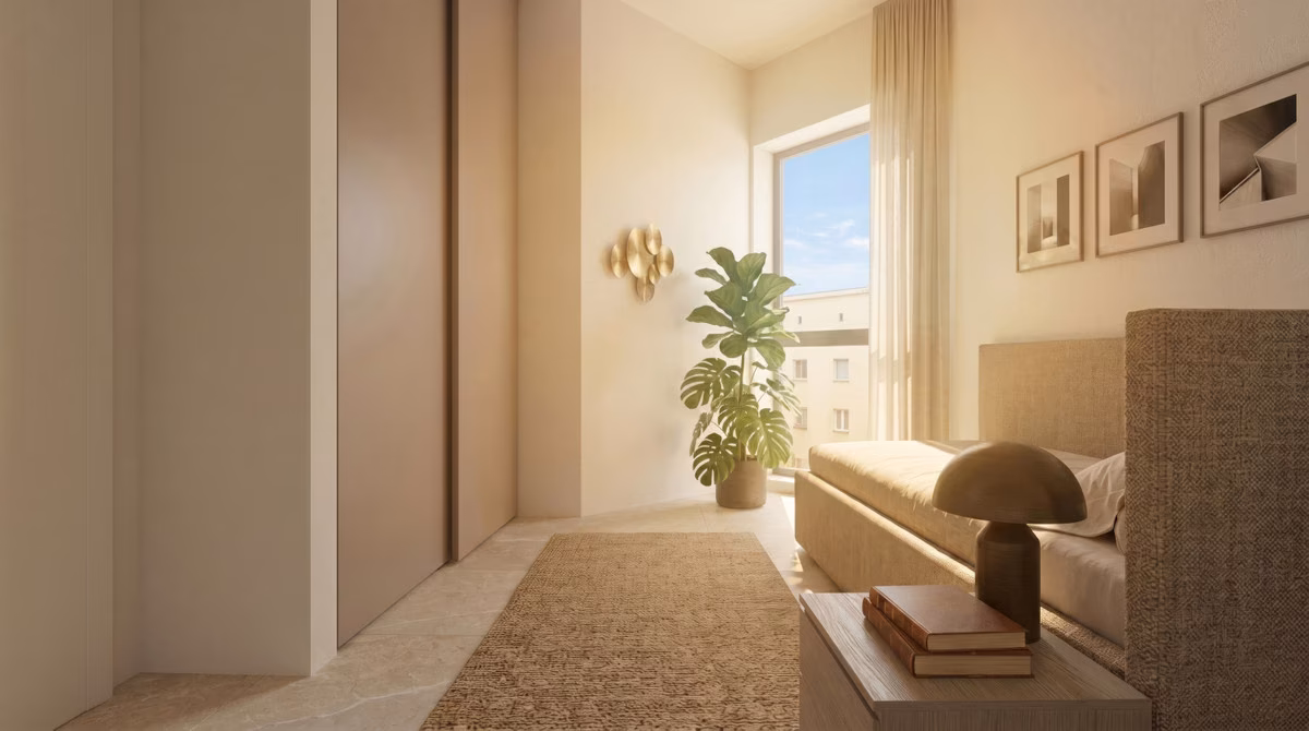 Bedroom with fitted wardrobes, sofa and window