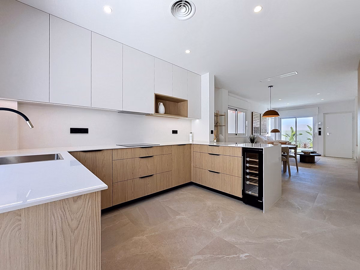 L-shaped kitchen in white and oak with a built-in wine cooler