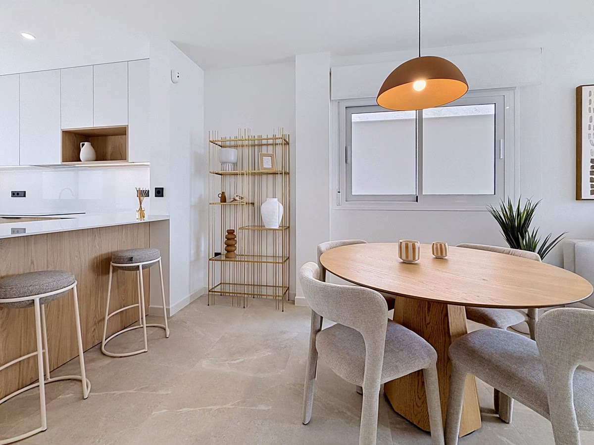 Dining area with round oak table beside the kitchen