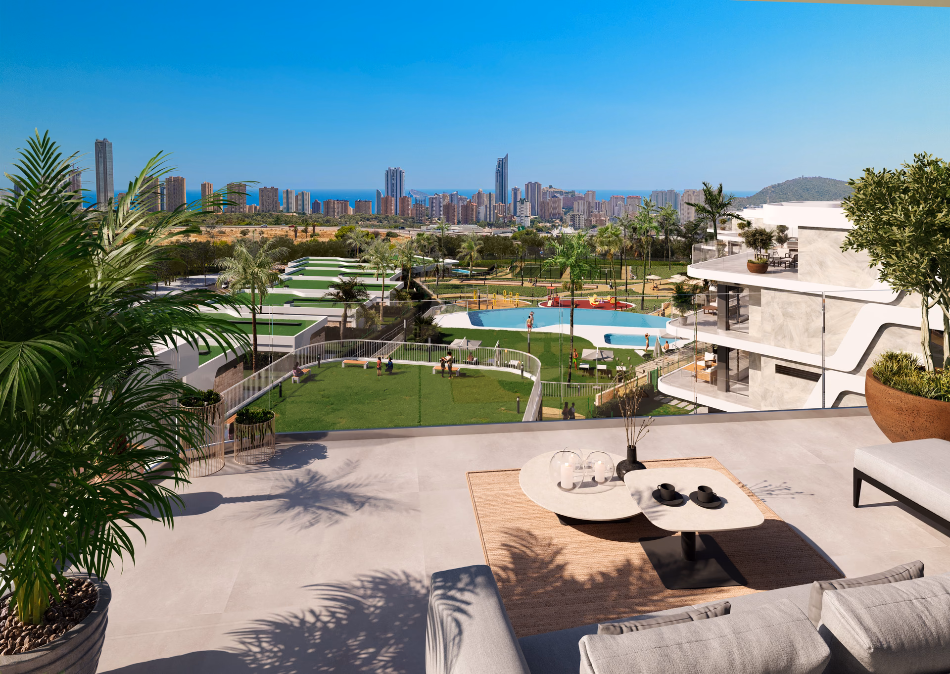 Render: terrace with outdoor sofas looking over the gardens to the Benidorm skyline
