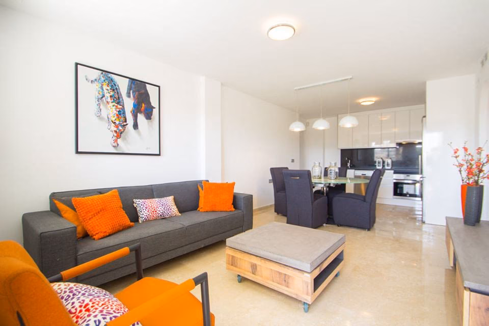 Open-plan living and dining room with the kitchen at the back