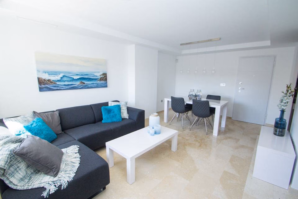Living room with corner sofa and white dining table