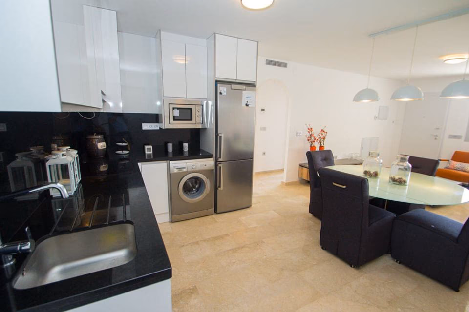 Kitchen corner with sink, washing machine and fridge-freezer