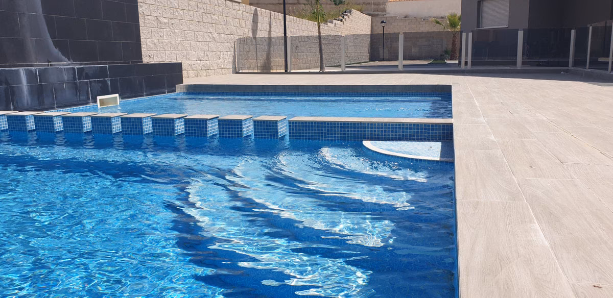 Communal pool with entry steps and the building behind