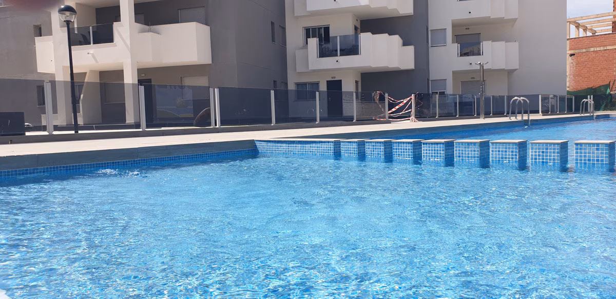 Long communal pool beside the apartment block