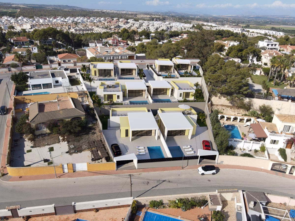 Aerial view of the villas among existing houses and pine trees in Los Balcones