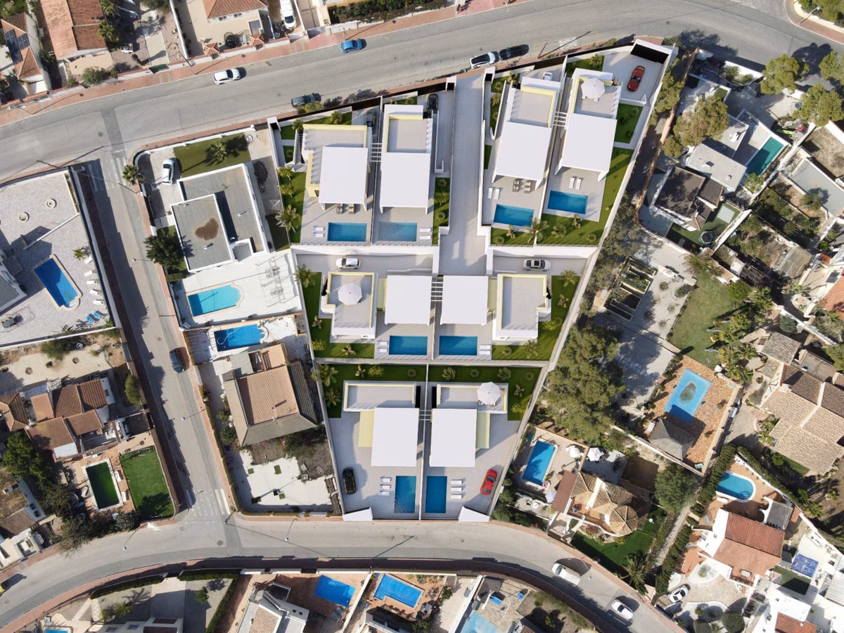 Top-down aerial view of the villas with private pools along the street