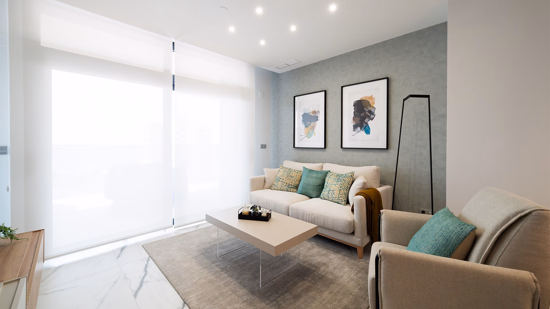 Living room with sofa and armchairs by the window