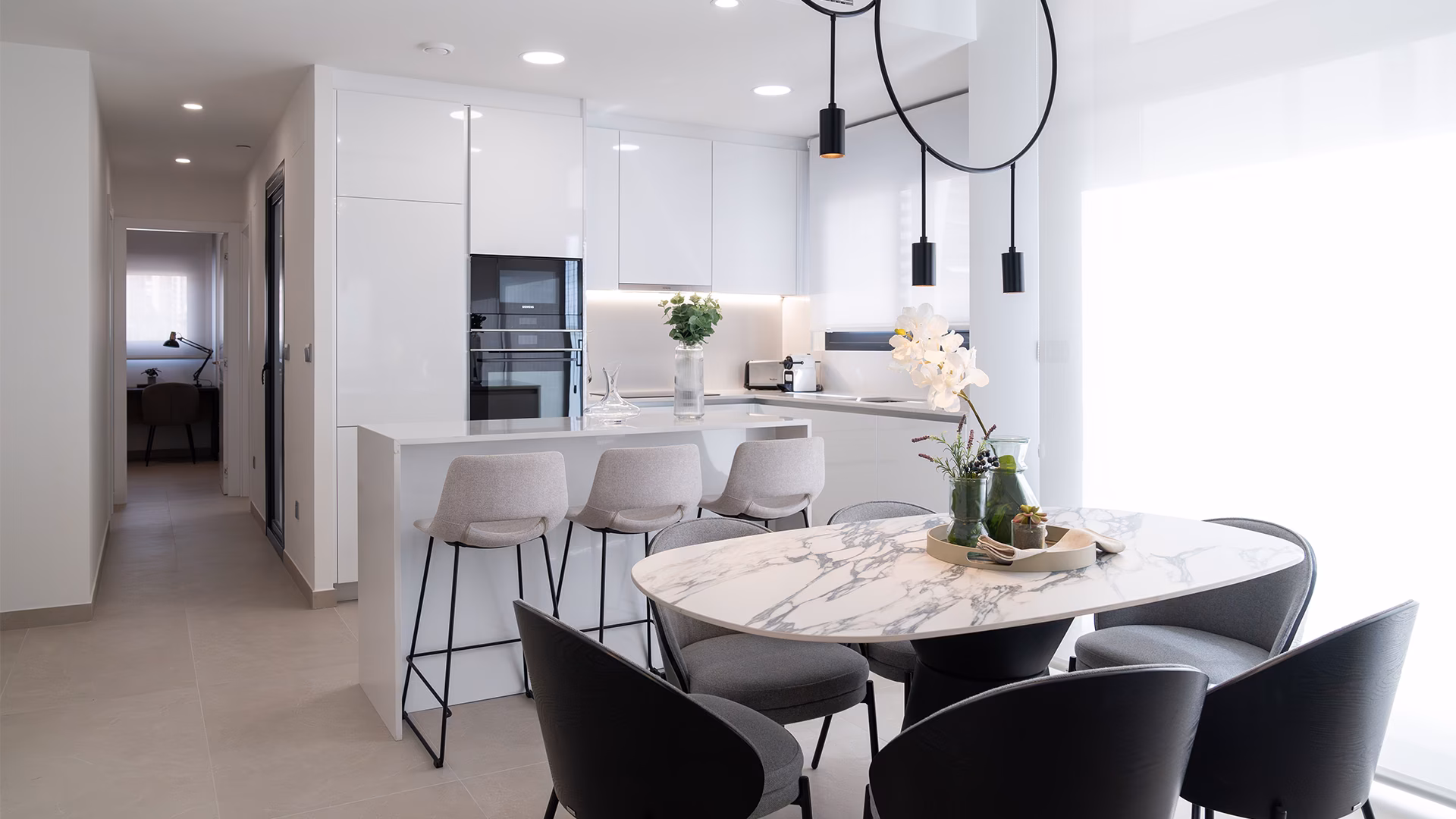 Kitchen with island, bar stools and round dining table